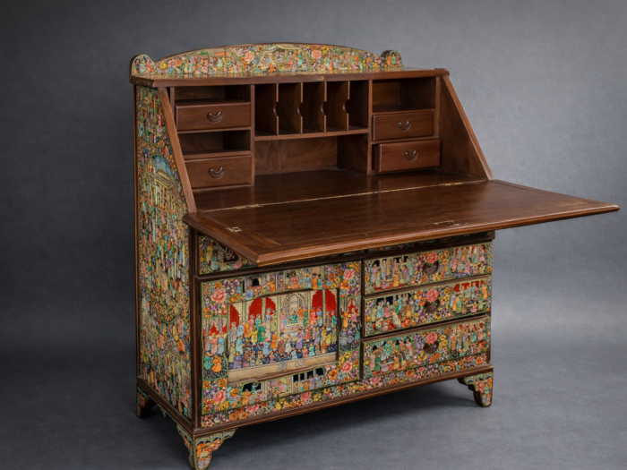 Hand painted secretary desk with fold-down writing surface and storage drawers, featuring Kashmiri Mughal miniature artwork in gold and red colors
