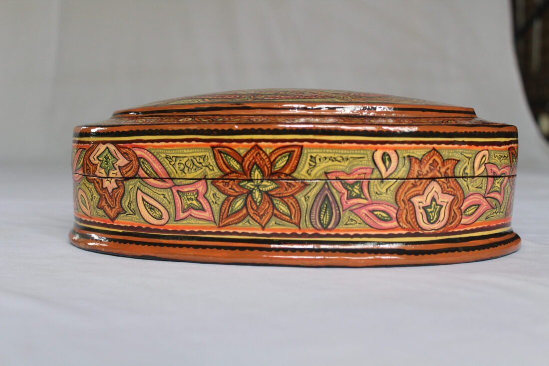 Round Kashmiri papier mache jewelry box with hand painted Persian paisley design and lacquered finish